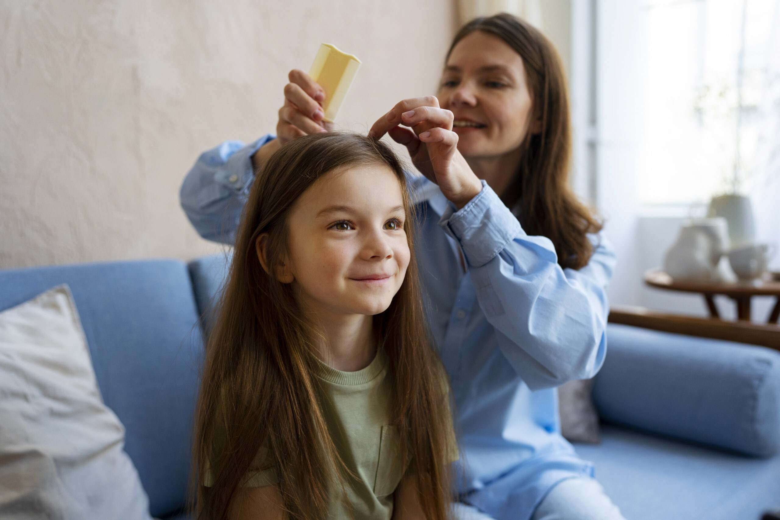 a happy child being checked for lice